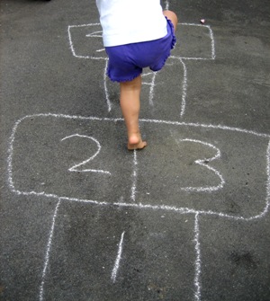 This photo of a child playing hopscotch was taken by Adrian in Canada.  Hopscotch - an outdoor game beloved across all generations ... educational, physical, and fun play.  Economical too ... and all you need is a sidewalk and piece of chalk! Oh, and don't forget the pair of agile legs.